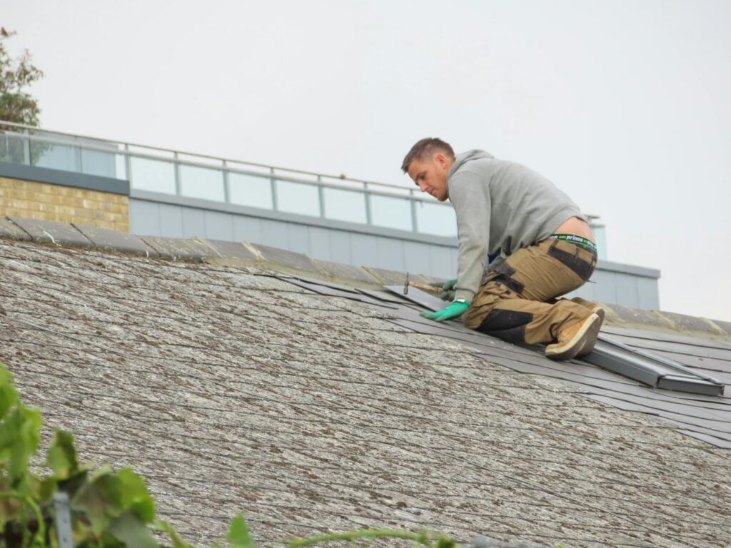 Roofing contractor installing shingles on a rooftop in Round Rock, Texas